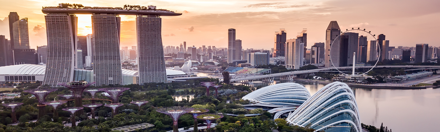 Aerial drone view of Singapore city skyline at sunset